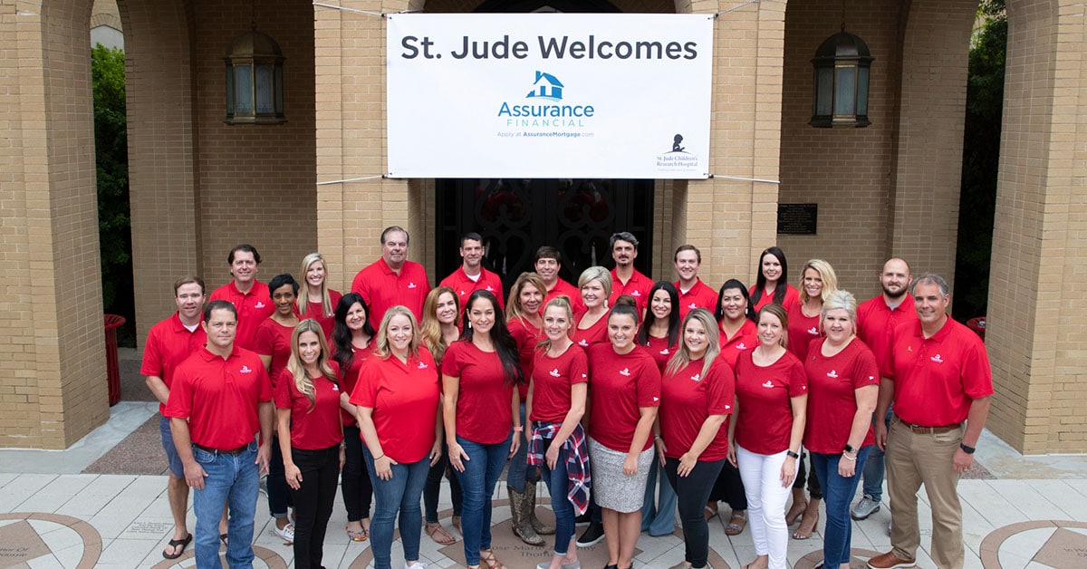 a group of people standing in front of a sign that says st. jude welcomes